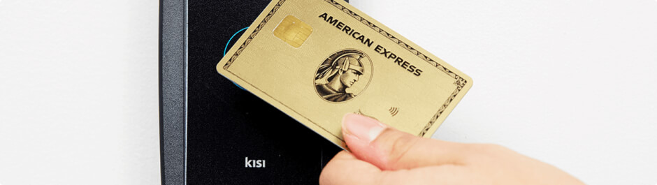 Woman accessing a room with a credit card and a Kisi reader